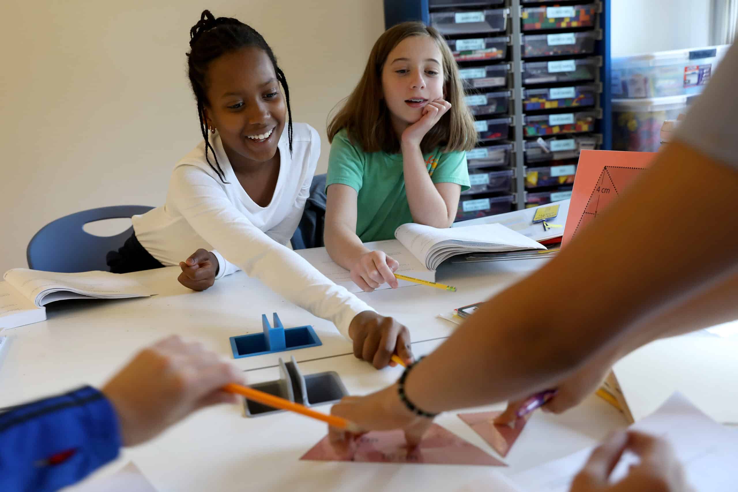 Four students work together to solve a math problem set